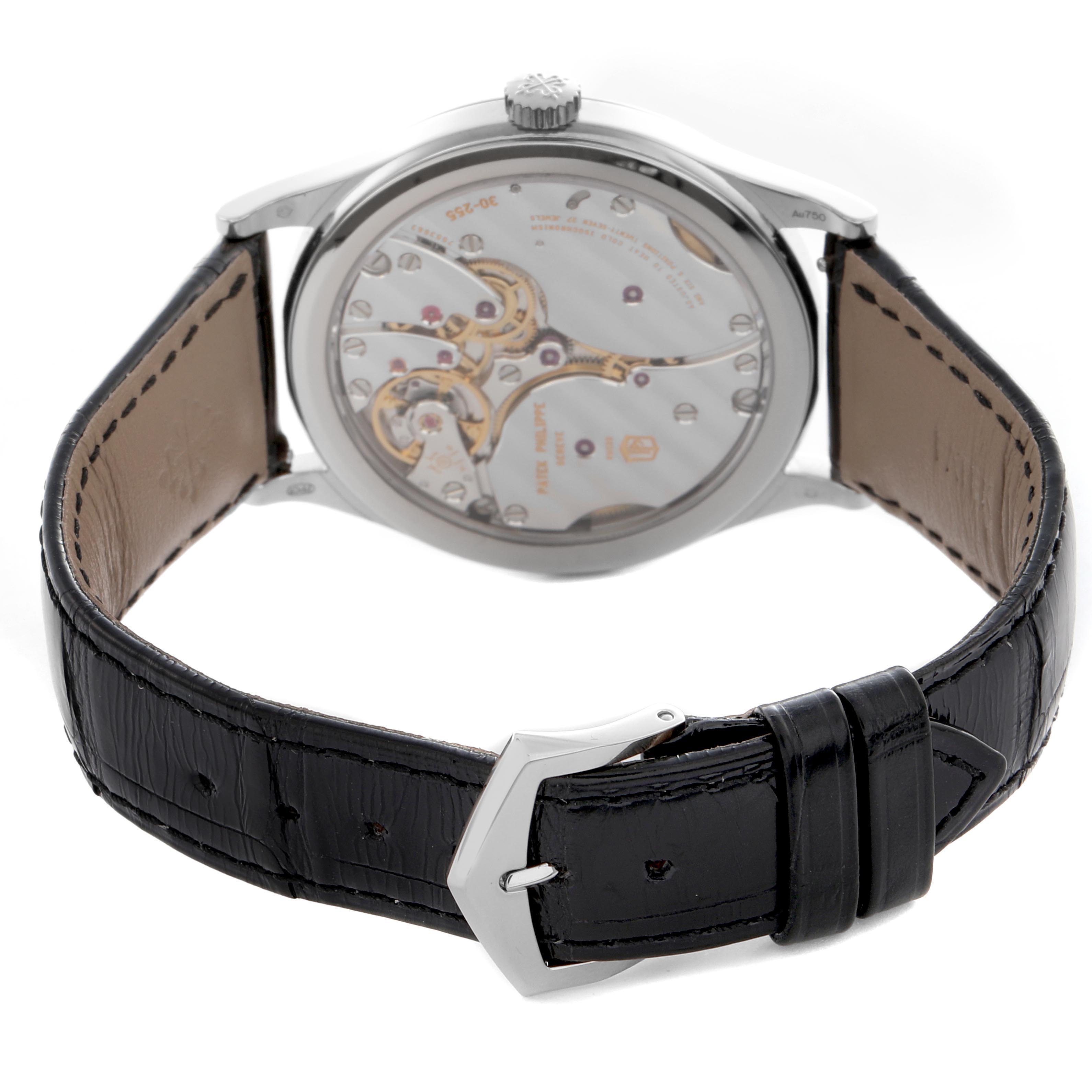 The image shows the back view of a Patek Philippe Calatrava 6119G Men's White Gold Grey Dial 6119G Men's White Gold Grey Dial, highlighting the movement and leather strap.