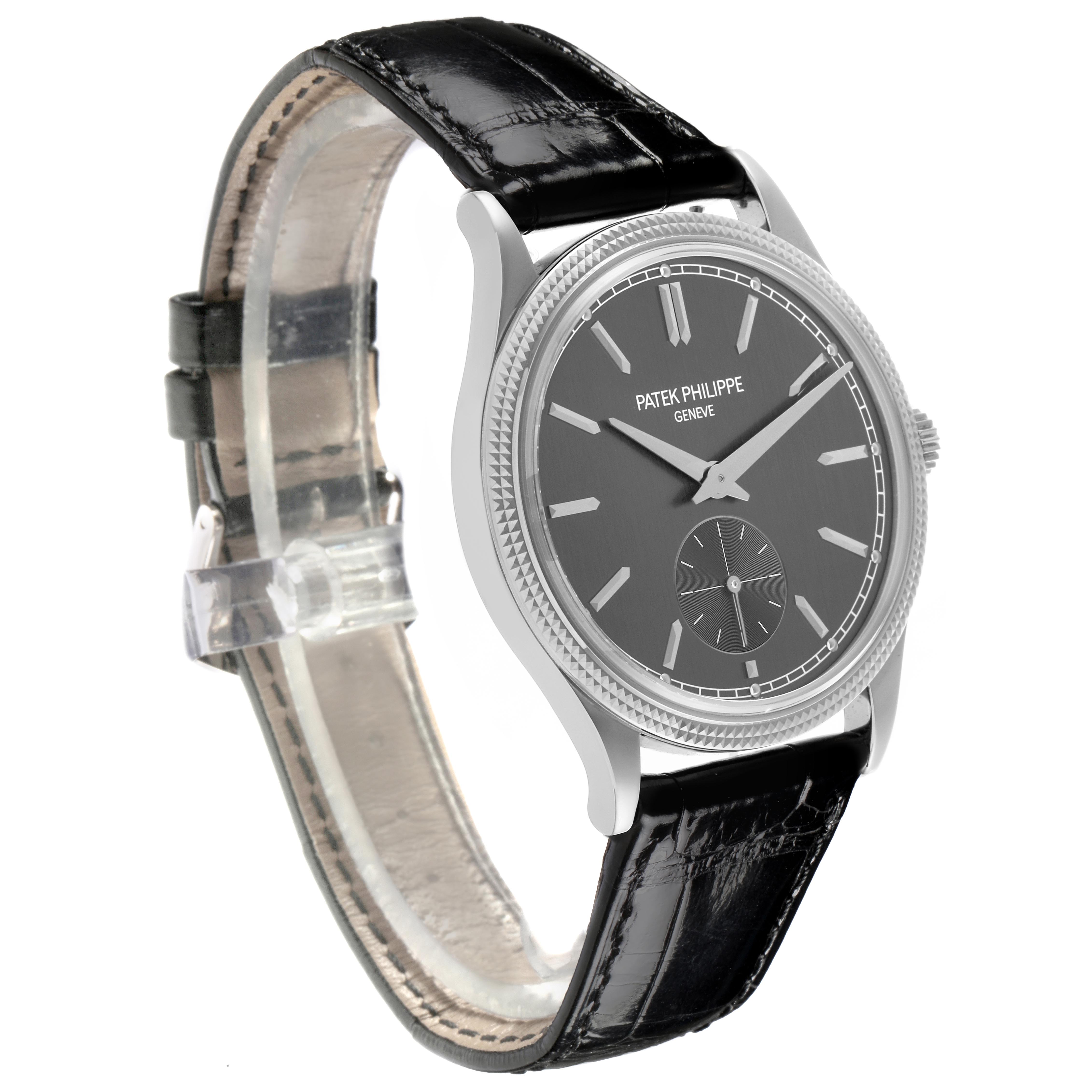 The Patek Philippe Calatrava 6119G Men's White Gold Grey Dial 6119G Men's White Gold Grey Dial watch is shown at a 3/4 angle, displaying its black dial, silver case, and black leather strap.