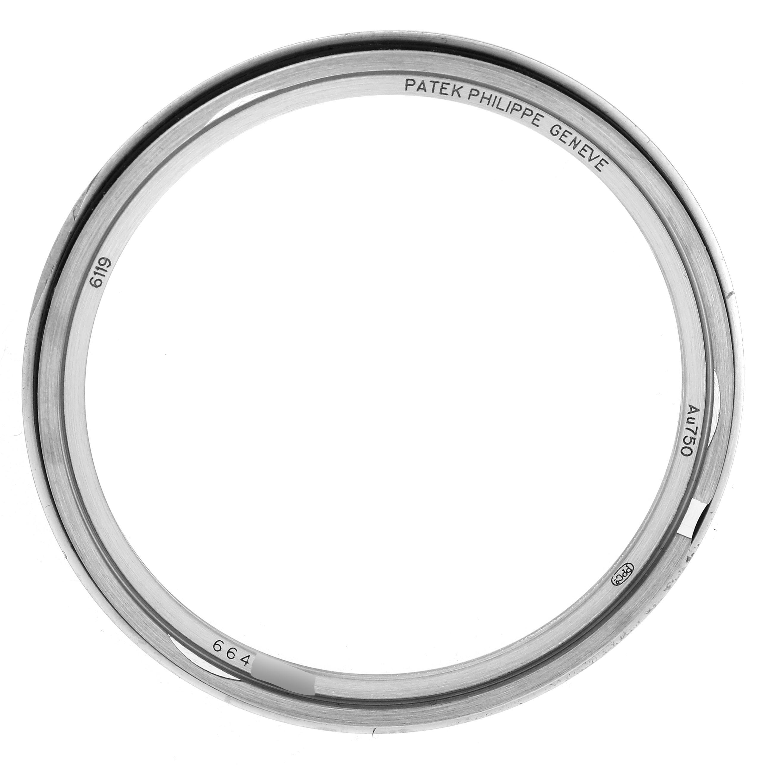 The image shows the metal bezel of a Patek Philippe Calatrava 6119G Men's White Gold Grey Dial 6119G Men's White Gold Grey Dial watch from a top-down angle.