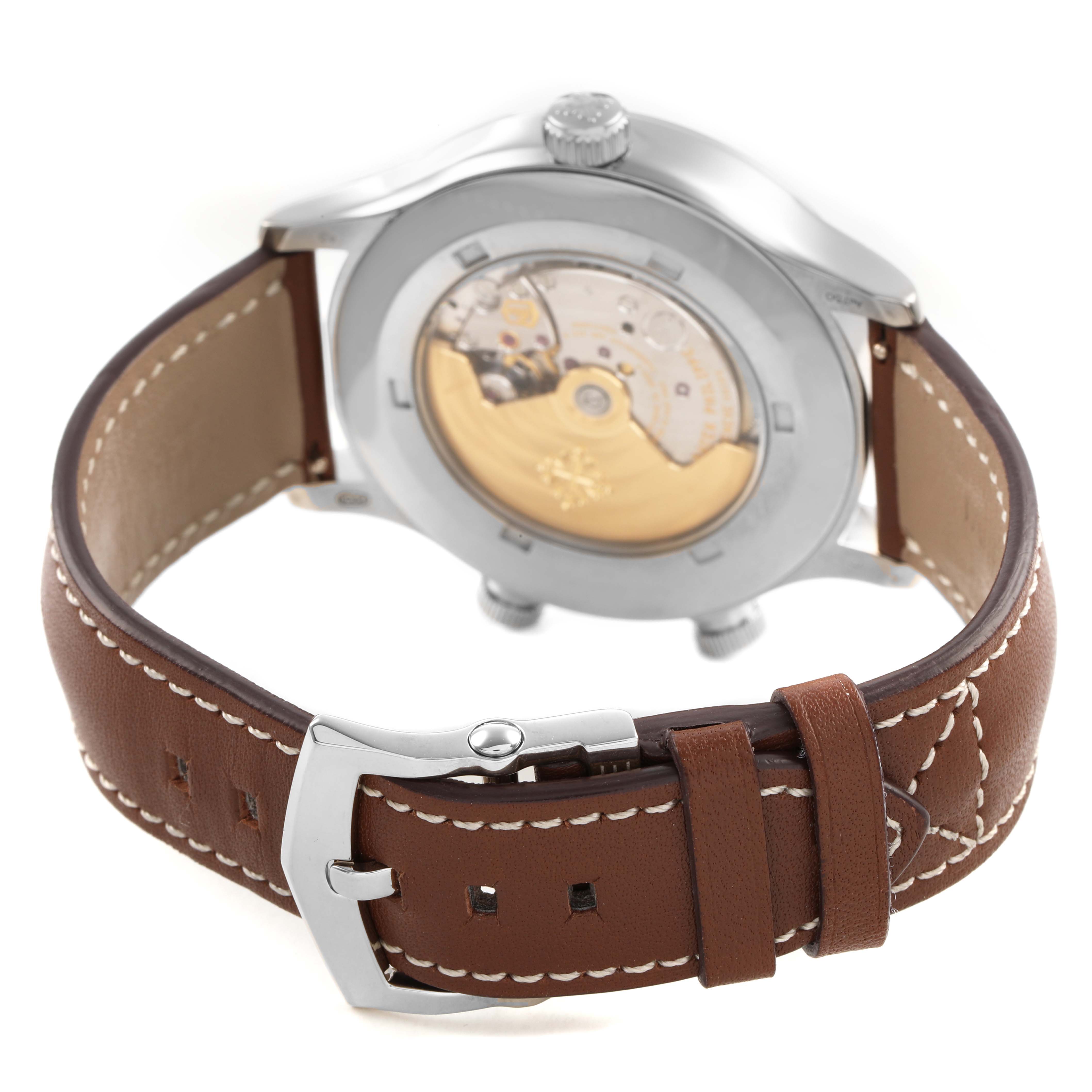 The image shows the back view of the Patek Philippe Calatrava 5524G-001 Men's White Gold Blue Dial, highlighting the mechanical movement and brown leather strap.