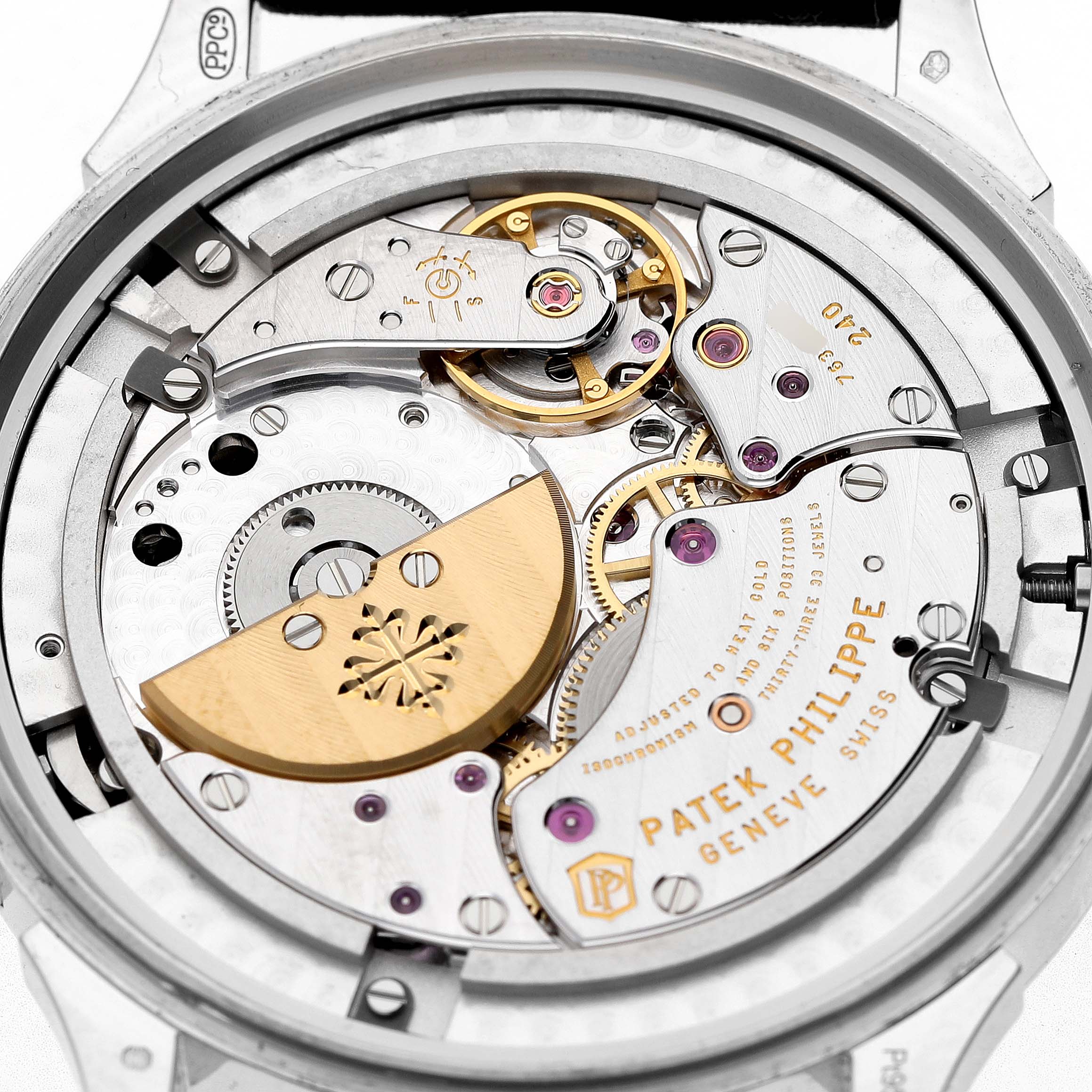 The image shows the movement's back view of a Patek Philippe Complications 5230P-001 Men's Platinum Blue Dial, highlighting gears and the rotor.