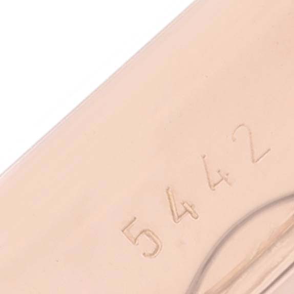 The image shows a close-up of partial engraving on a Rolex Cellini 5442 Men's Rose Gold Black Dial watch, with numbers visible.