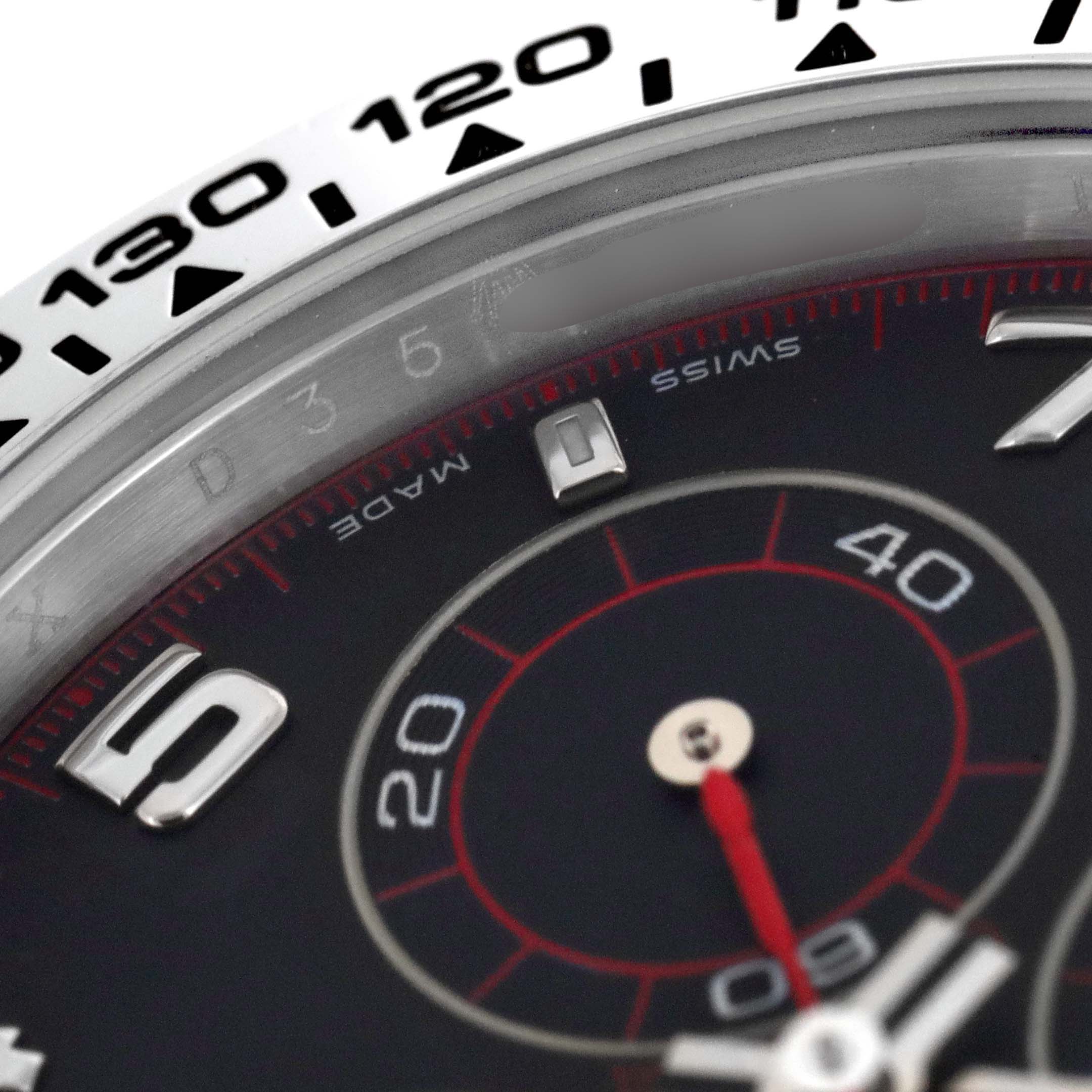 The image shows a close-up of the bezel and part of the dial of the Rolex Daytona 116509 Men's White Gold Black Dial 116509 Men's White Gold Black Dial watch, focused on the numerals and markers.