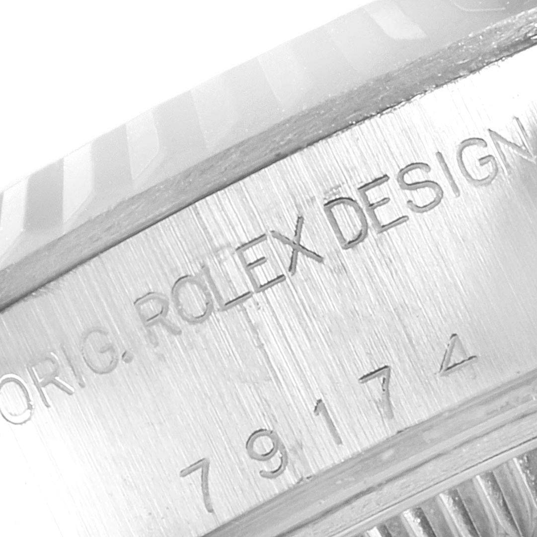 This close-up image shows the embossed text "ORIG. ROLEX DESIGN" and part of the serial number on the side of a Rolex Datejust 79174 Women
s Stainless Steel Silver Dial 79174 Women
s Stainless Steel Silver Dial watch.