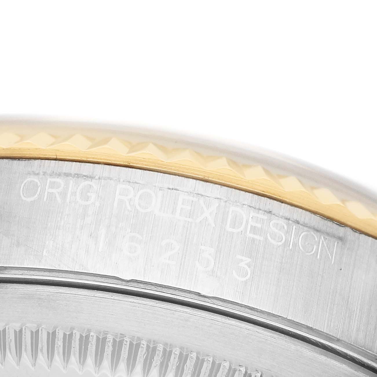 The image shows a close-up of the side of a Rolex Datejust 16233 Men's Stainless Steel Champagne Dial, highlighting the bezel and engraved serial number.
