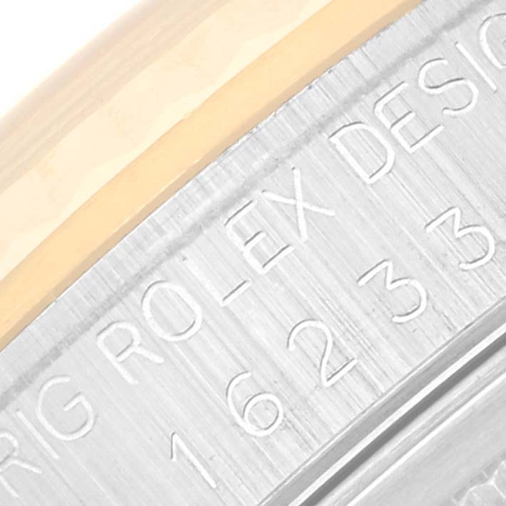 The image shows a close-up of the side engraving on a Rolex Datejust 16233 Men's Steel and Gold (two tone) Blue Dial 16233 Men's Steel and Gold (two tone) Blue Dial watch, displaying part of the model number and brand name.