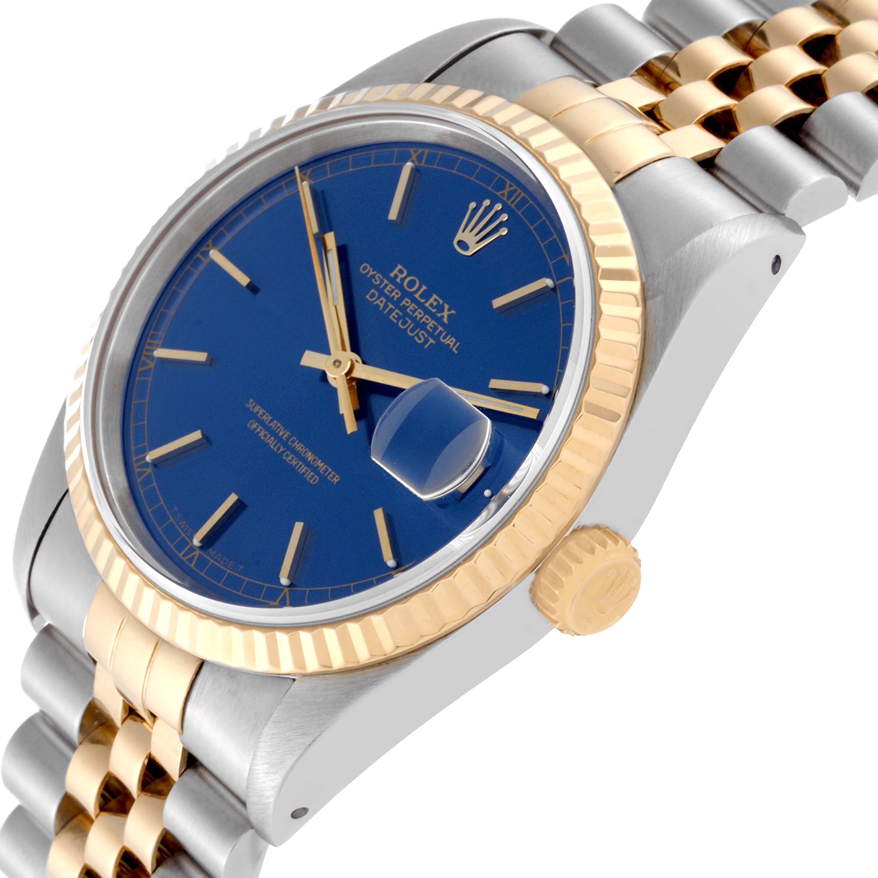 The Rolex Datejust 16233 Men's Steel and Gold (two tone) Blue Dial 16233 Men's Steel and Gold (two tone) Blue Dial watch is pictured at an angle showing the blue dial, fluted bezel, and Jubilee bracelet.