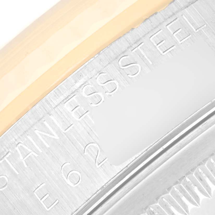 The image shows a close-up of the stainless steel case back and edge of the bezel of a Rolex Datejust 16233 Men's Steel and Gold (two tone) Blue Dial 16233 Men's Steel and Gold (two tone) Blue Dial watch.