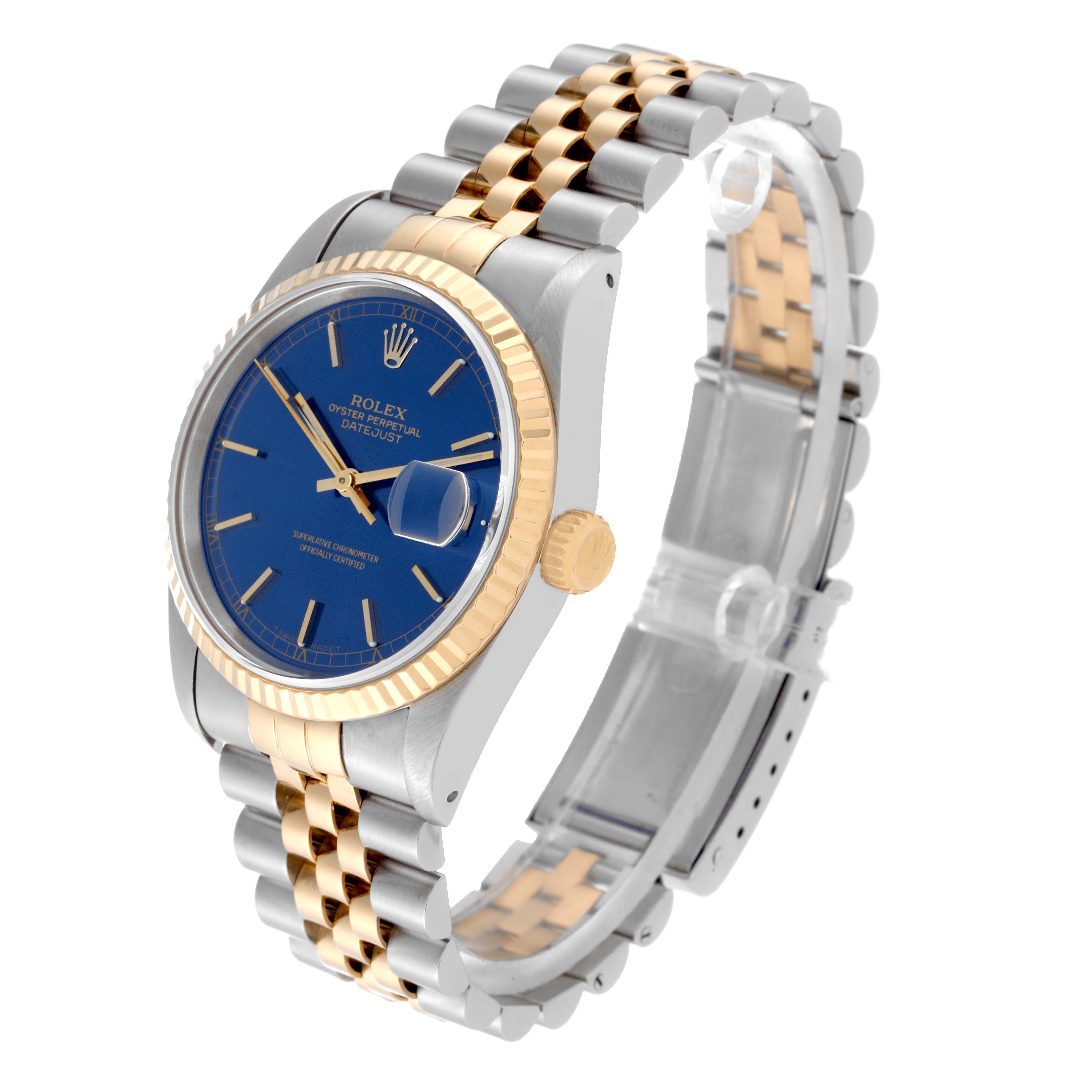 This image shows a Rolex Datejust 16233 Men's Steel and Gold (two tone) Blue Dial 16233 Men's Steel and Gold (two tone) Blue Dial watch angled from the upper left, highlighting the blue dial, gold fluted bezel, and two-tone bracelet.