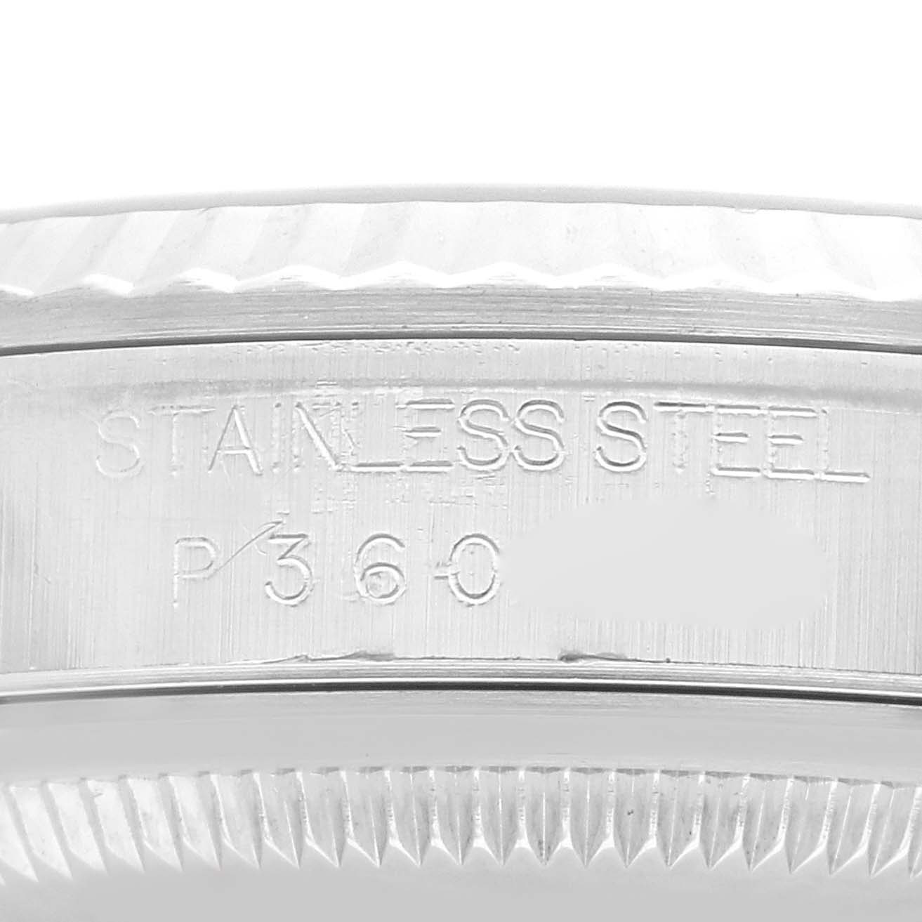 The image shows a close-up of the side of a Rolex Datejust 16234 Men's Stainless Steel Black Dial 16234 Men's Stainless Steel Black Dial watch case with engraved text and part of the bezel.