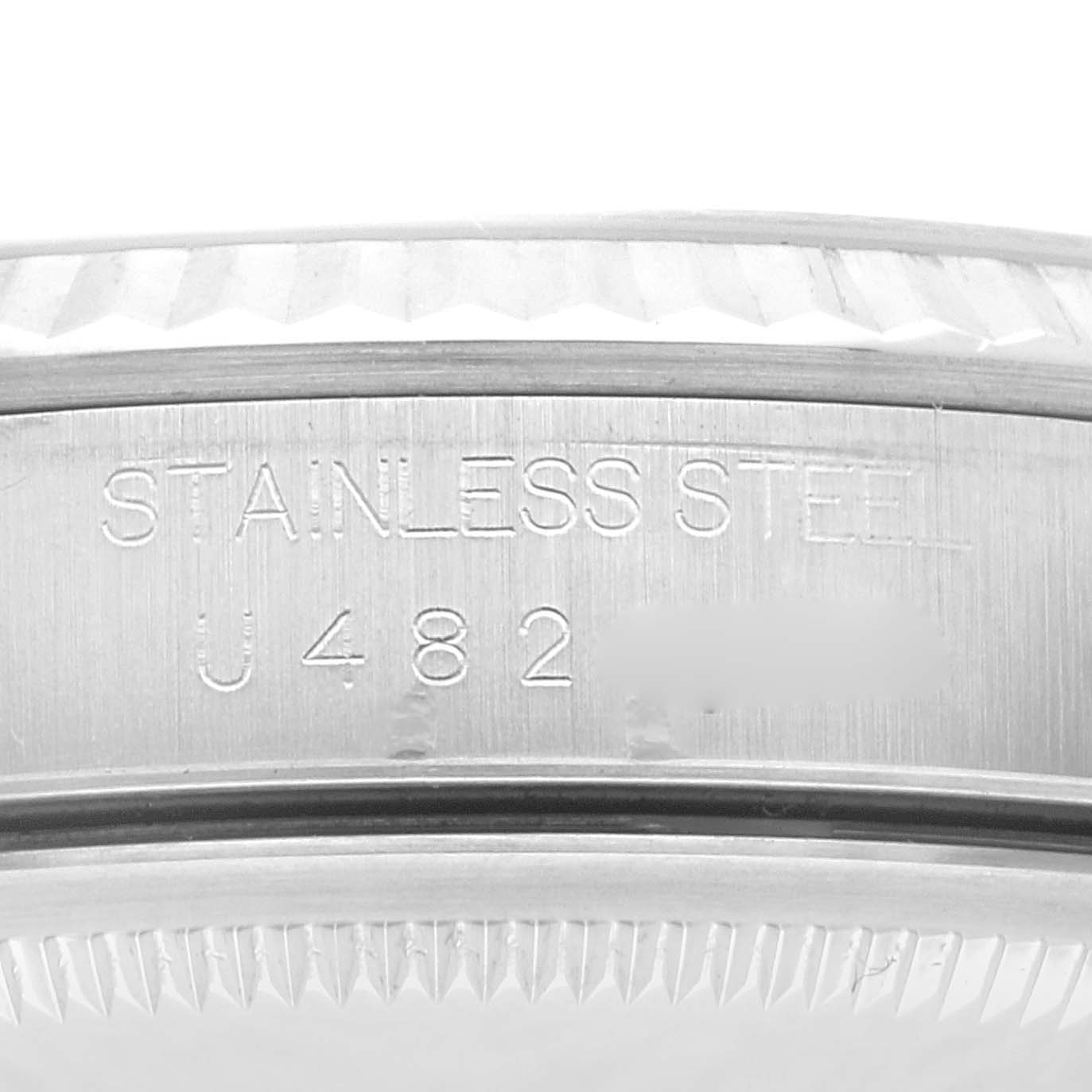 The image shows a close-up of the side of a Rolex Datejust 16234 Men's Stainless Steel Blue Dial, highlighting the stainless steel casing and serial number.