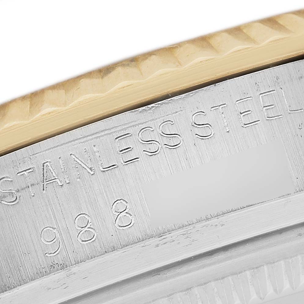 The image shows a close-up of the bezel and part of the casing on a Rolex Datejust 16013 Men's Steel and Gold (two tone) Champagne Dial, highlighting "STAINLESS STEEL" engravings.