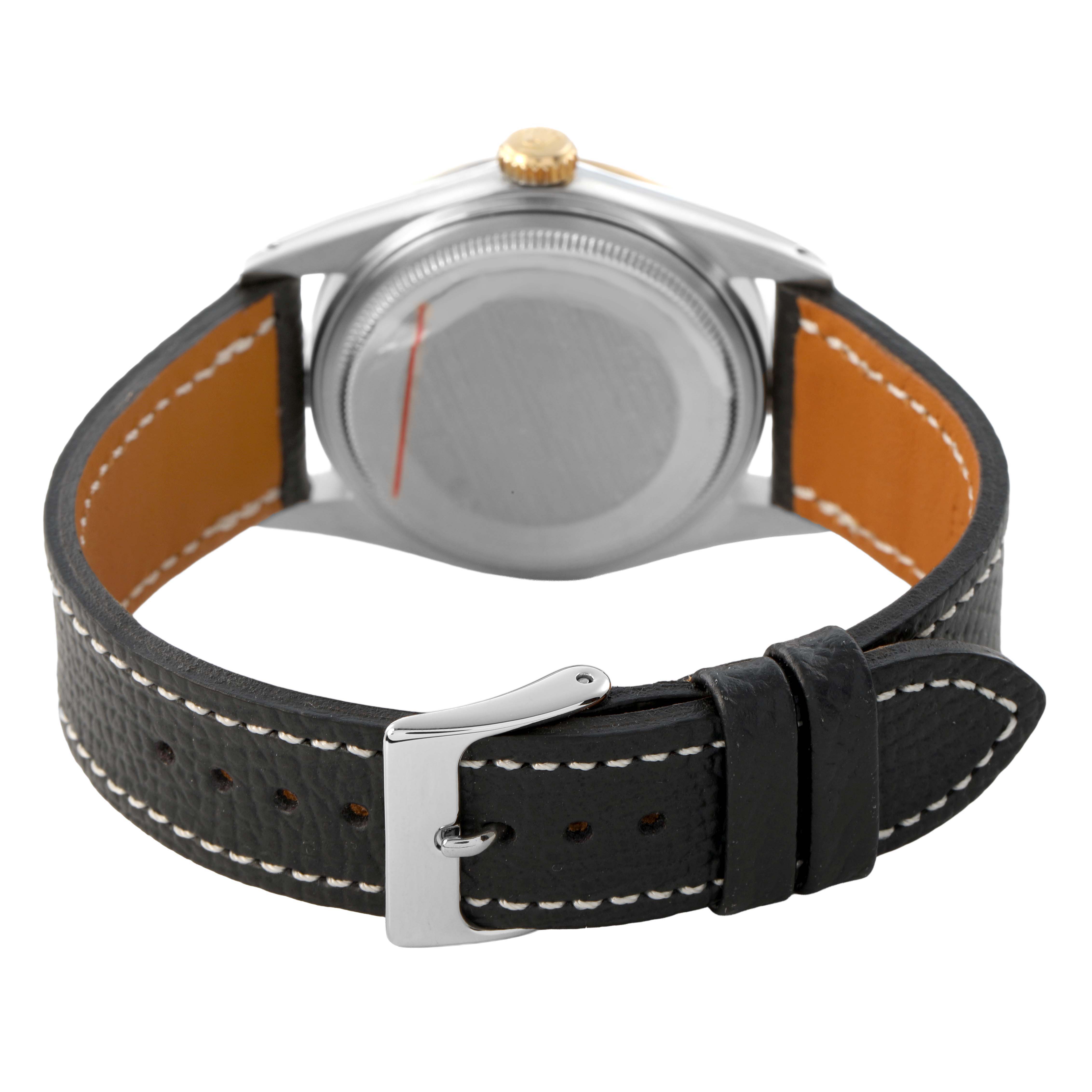 The Rolex Datejust 16013 Men's Steel and Gold (two tone) Champagne Dial watch is shown from the back, displaying its case, crown, and leather strap with a buckle.