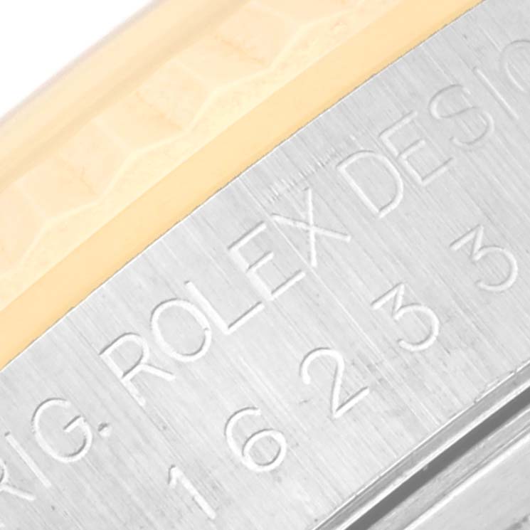 This is a close-up of a Rolex Datejust 16233 Men's Steel and Gold (two tone) Black Dial 16233 Men's Steel and Gold (two tone) Black Dial model, specifically showing part of the serial numbers and engraving on the watch case.