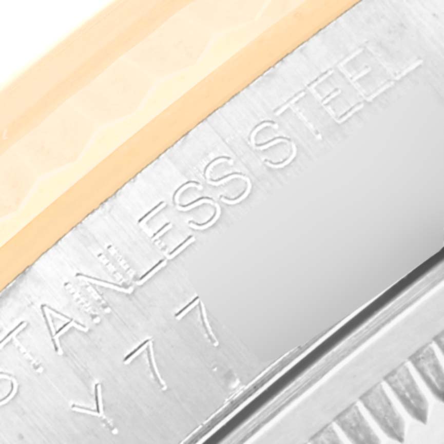 This close-up image of the Rolex Datejust 16233 Men's Steel and Gold (two tone) Black Dial 16233 Men's Steel and Gold (two tone) Black Dial shows part of the stainless steel casing with engraved text.