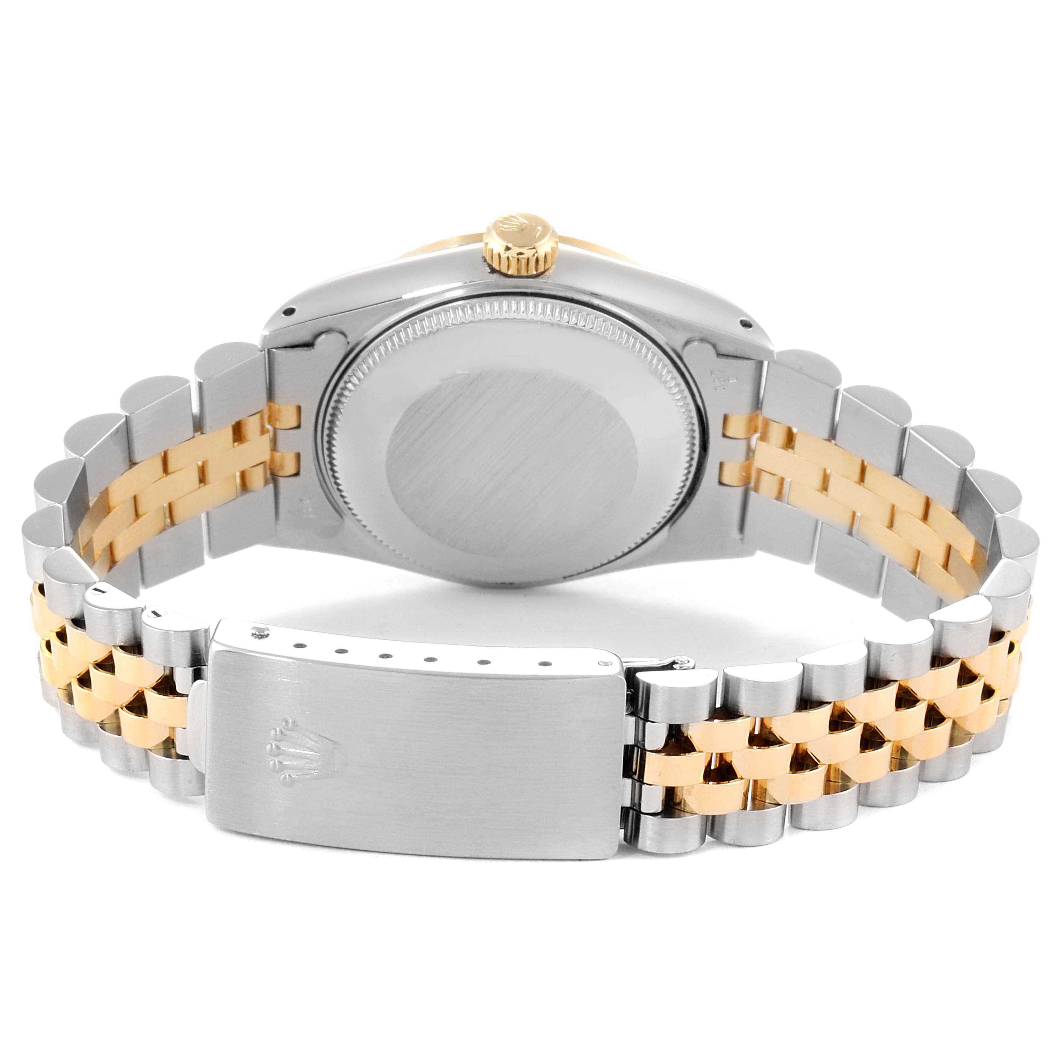 The image shows the back case, crown, and bracelet of a Mid-Size Rolex watch, viewed from the rear.