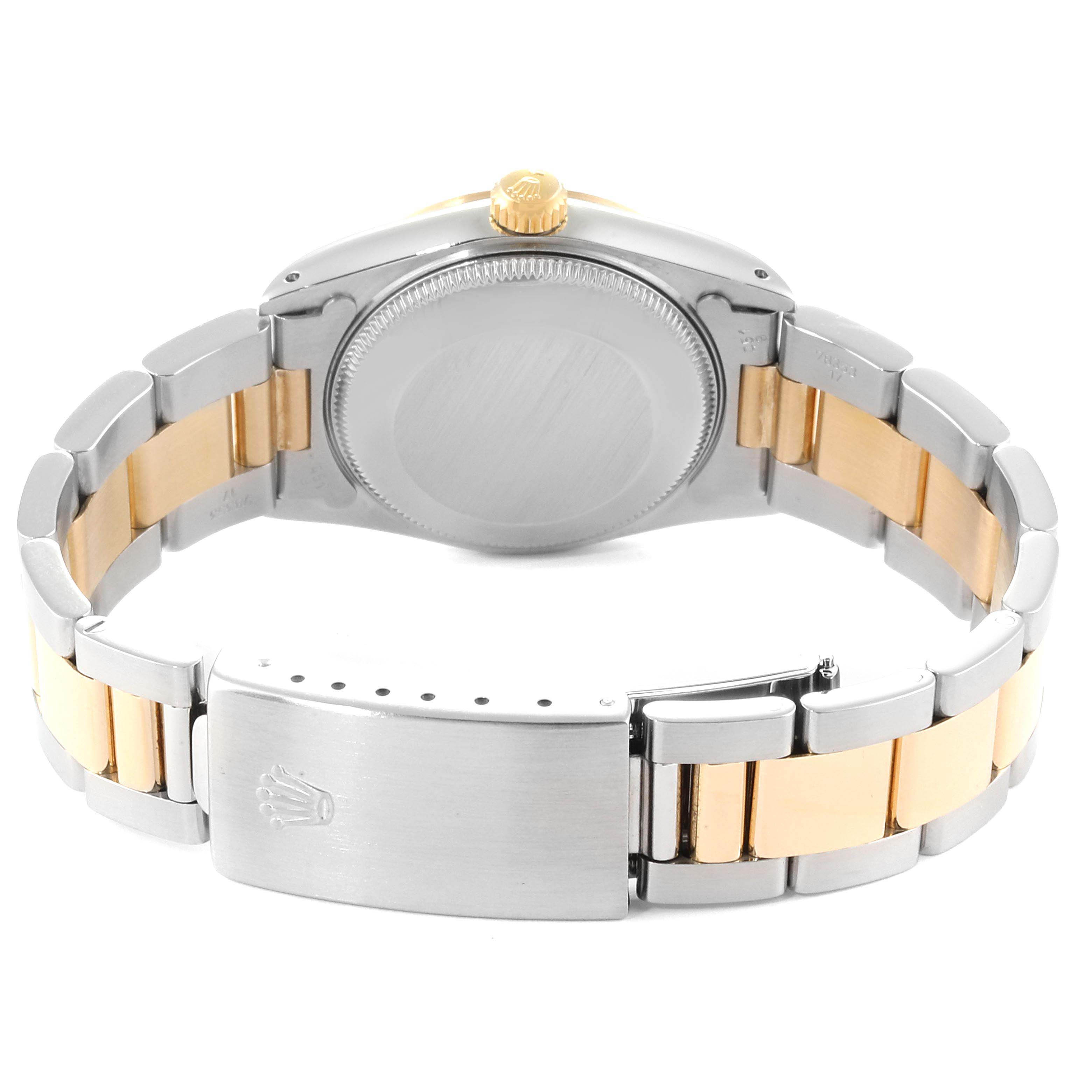 The image shows the back view of a Rolex Mid-Size 68243 Women
s Steel and Gold (two tone) Beige Dial 68243 Women
s Steel and Gold (two tone) Beige Dial model watch, highlighting the case back and the two-tone metal bracelet with a clasp.