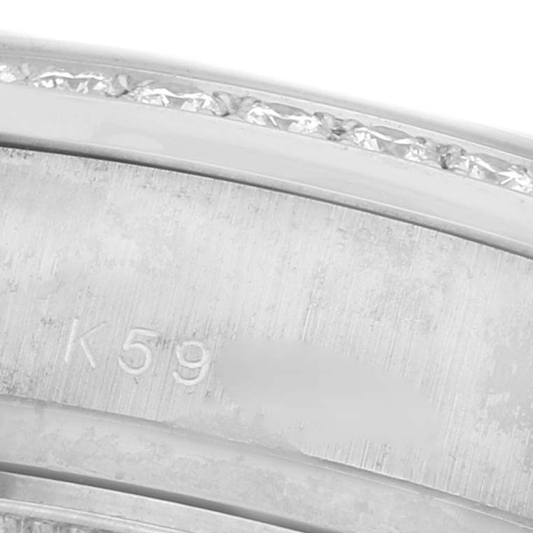 The image shows a close-up of the side of a Rolex President 179159 Women's White Gold White Dial 179159 Women's White Gold White Dial watch, focusing on its engraved inner bezel and diamonds on the outer edge.