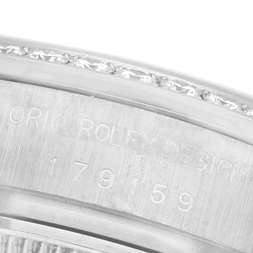 The image shows a close-up of the side of a Rolex President 179159 Women's White Gold White Dial 179159 Women's White Gold White Dial watch, highlighting its engraved design details.