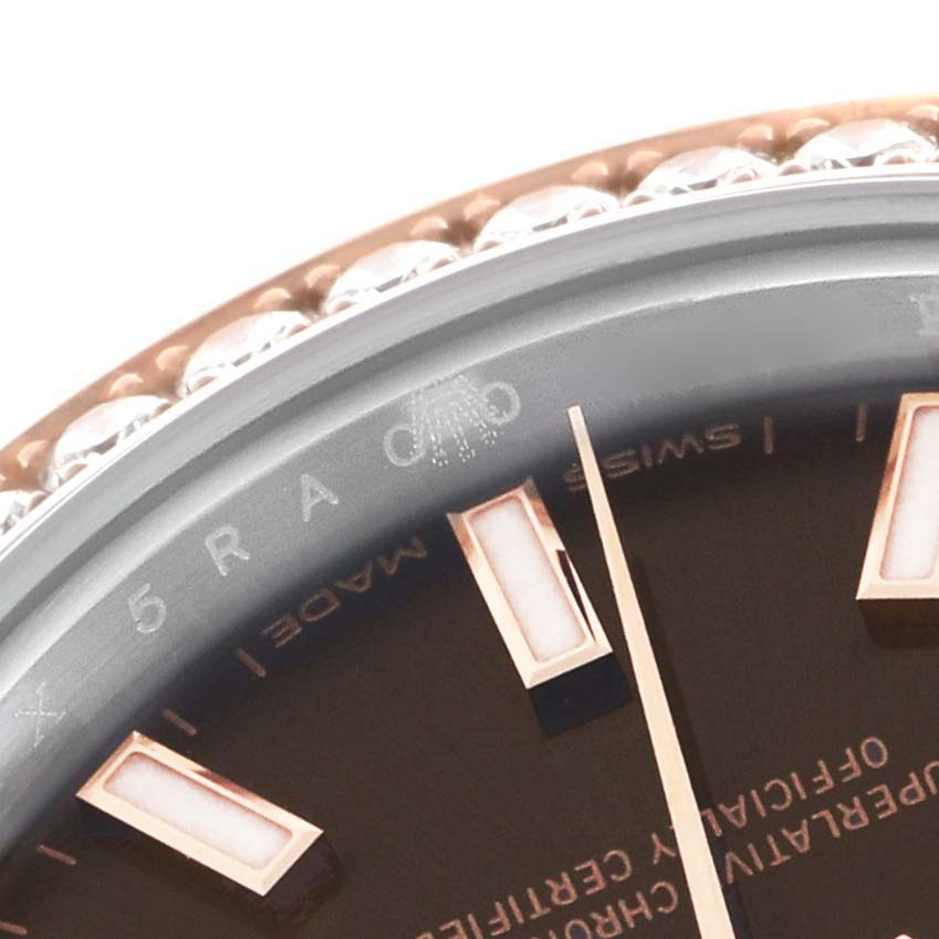 The image shows a close-up of the dial and bezel of a Rolex Datejust 279381 Women's Steel and Gold (two tone) Brown Dial 279381 Women's Steel and Gold (two tone) Brown Dial watch, highlighting the hour markers and part of the minute hand.