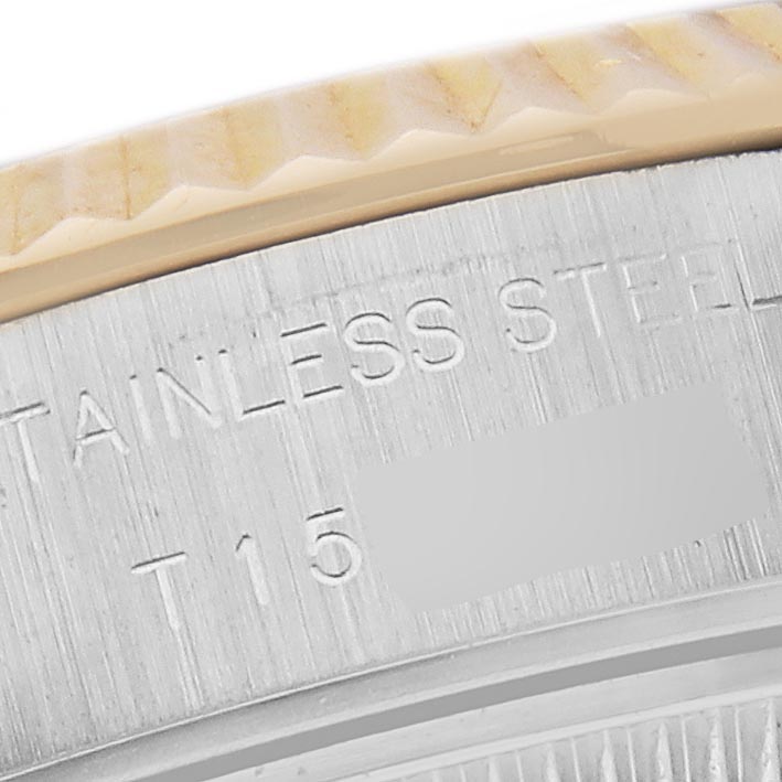 The image shows a close-up of the Rolex Datejust 69173 Women's Steel and Gold (two tone) Silver Dial 69173 Women's Steel and Gold (two tone) Silver Dial's fluted bezel edge and engraved stainless steel case.