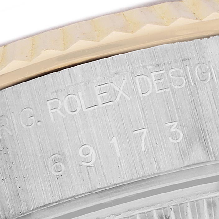 The image shows a close-up of the side of a Rolex Datejust 69173 Women's Steel and Gold (two tone) Silver Dial 69173 Women's Steel and Gold (two tone) Silver Dial, highlighting the case with engraved serial numbers.