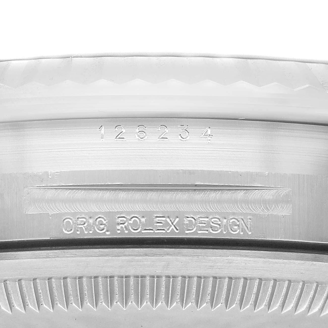The image shows a close-up of the case side and bezel of a Rolex Datejust 126234 Men's Stainless Steel Blue Dial 126234 Men's Stainless Steel Blue Dial model, highlighting its serial number and "ORIG ROLEX DESIGN" engraving.