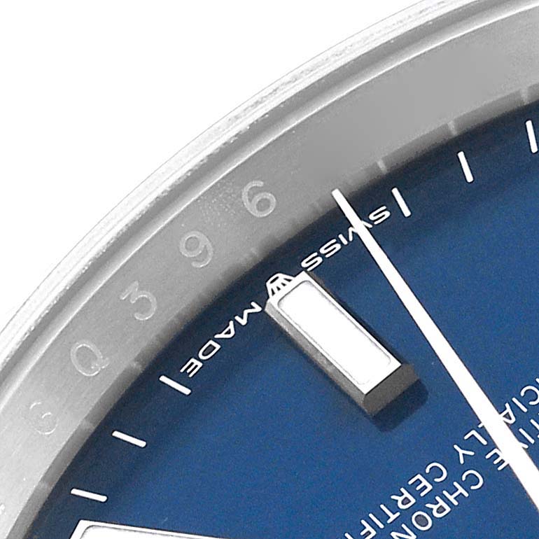 This close-up image of a Rolex Datejust 126234 Men's Stainless Steel Blue Dial 126234 Men's Stainless Steel Blue Dial watch shows part of the blue dial, an hour marker, and the edge of the bezel.