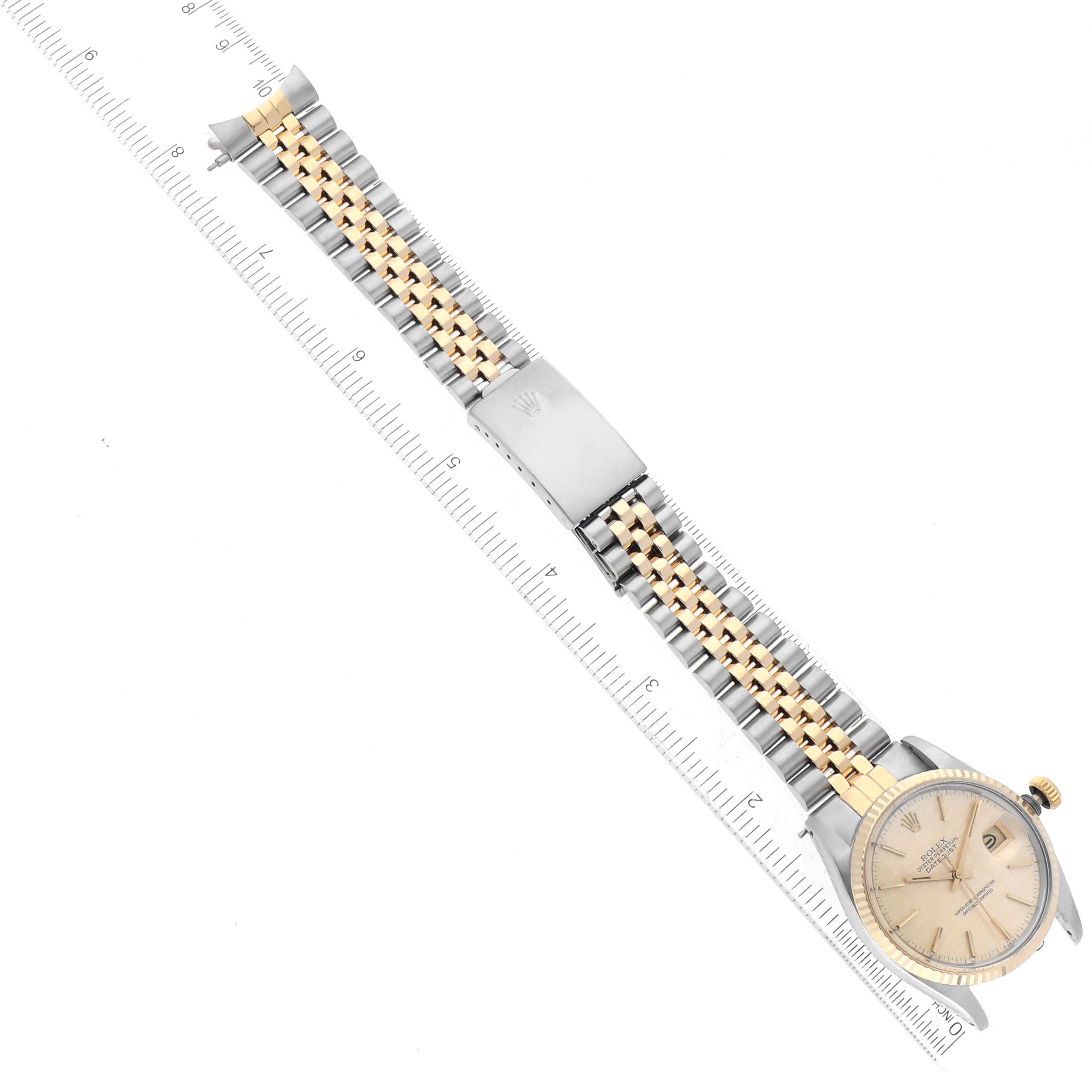 This image shows a Vintage Collection Rolex watch laid flat, displaying its face, bracelet, and clasp, with a ruler aligned alongside it.