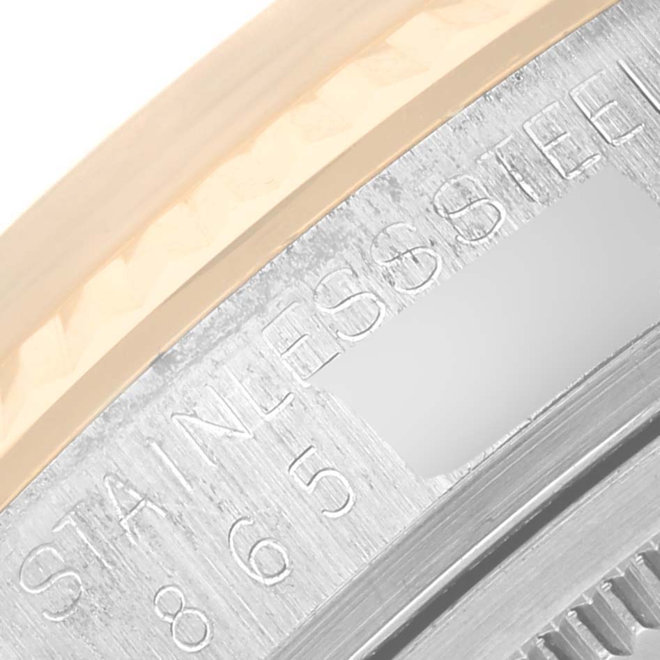 The image shows a close-up of the side of the bezel and the engraved stainless steel case of a Rolex Vintage Collection 16013 Men's Steel and Gold (two tone) Champagne Dial 16013 Men's Steel and Gold (two tone) Champagne Dial watch.