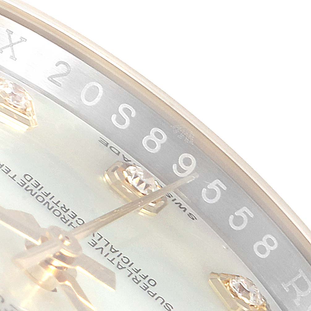This close-up shows the dial and partial bezel of a Rolex Datejust 116243 Men
s Steel and Gold (two tone) Mother of Pearl Dial 116243 Men
s Steel and Gold (two tone) Mother of Pearl Dial watch, including some hour markers and hands.