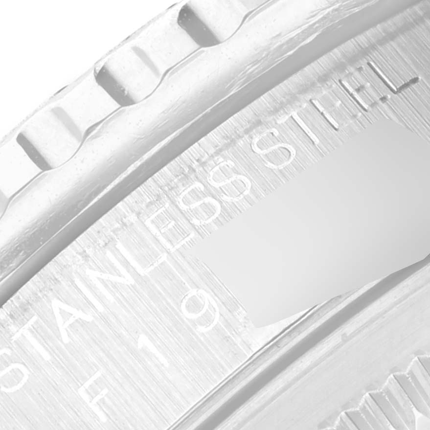 This close-up image shows a part of the stainless steel case back of the Rolex Turn-o-Graph 16264 Men's Stainless Steel Black Dial 16264 Men's Stainless Steel Black Dial watch.