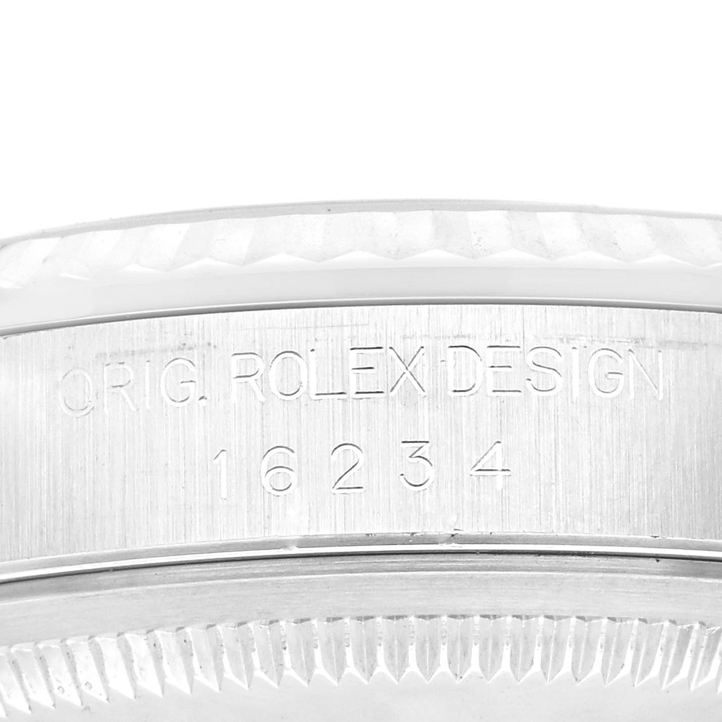 The image shows a close-up of the side of the Rolex Datejust 16234 Men's Stainless Steel White Dial 16234 Men's Stainless Steel White Dial watch case, highlighting the engraving and bezel.