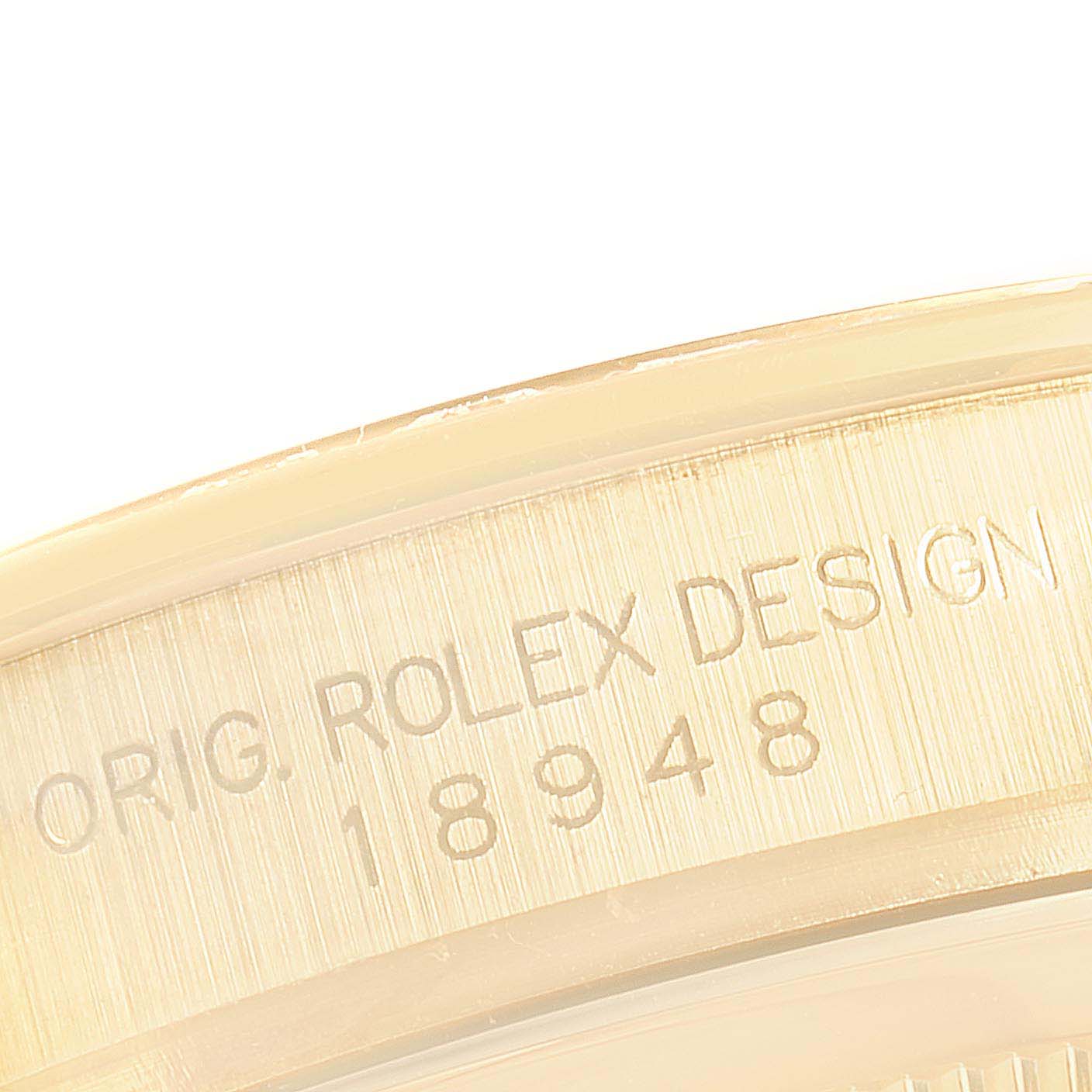 The image shows a close-up of the edge of a Rolex President  Men
s Yellow Gold Silver Dial  Men
s Yellow Gold Silver Dial model watch, highlighting the engraved serial number and original design inscription.