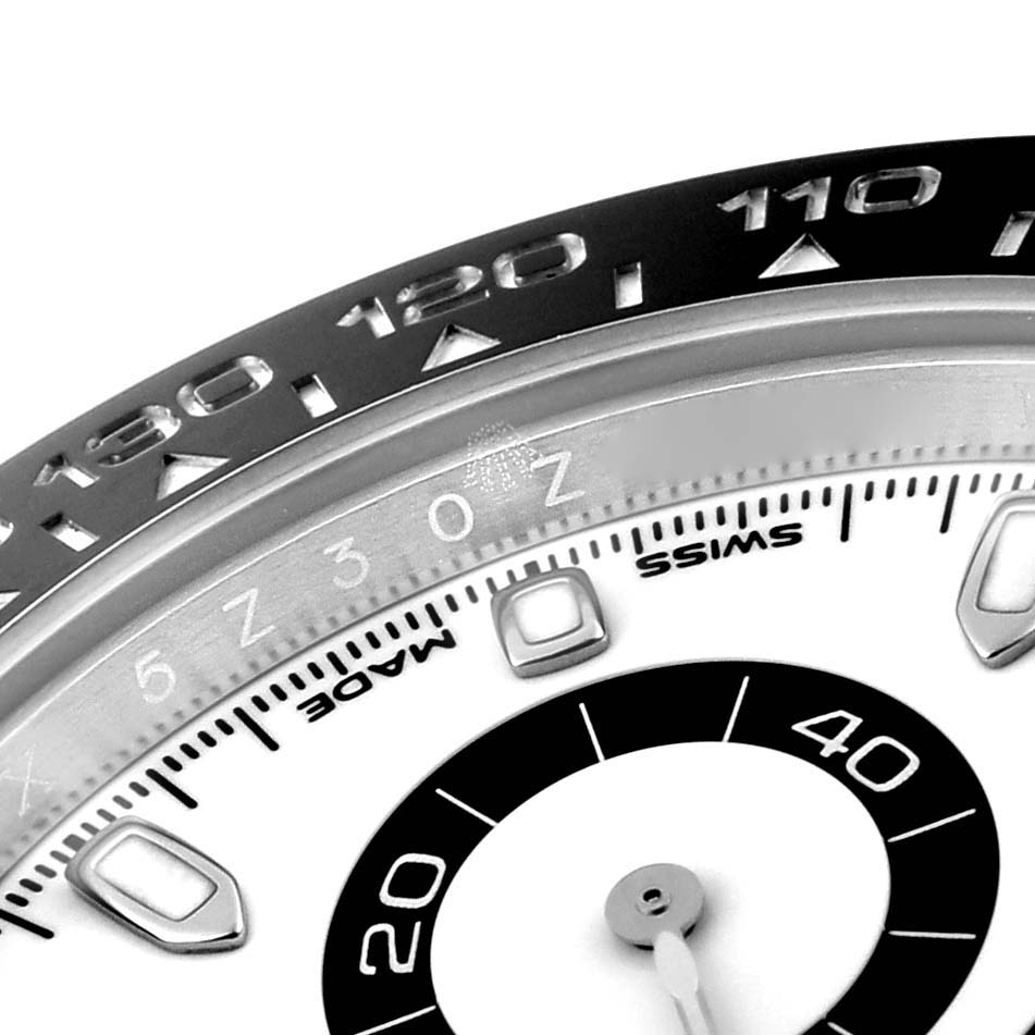The image shows a close-up of the dial and bezel of a Rolex Daytona 116500 Men's Stainless Steel White Dial 116500 Men's Stainless Steel White Dial watch, displaying details of the sub-dials and tachymeter scale.