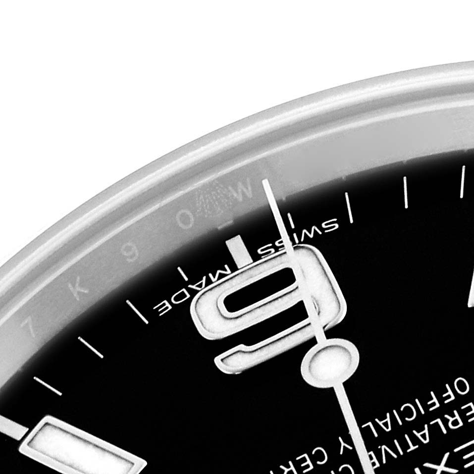 The image shows a close-up of the dial on a Rolex Explorer 214270 Men's Stainless Steel Black Dial 214270 Men's Stainless Steel Black Dial watch, focusing on the "9" index and part of the hour and minute hands.