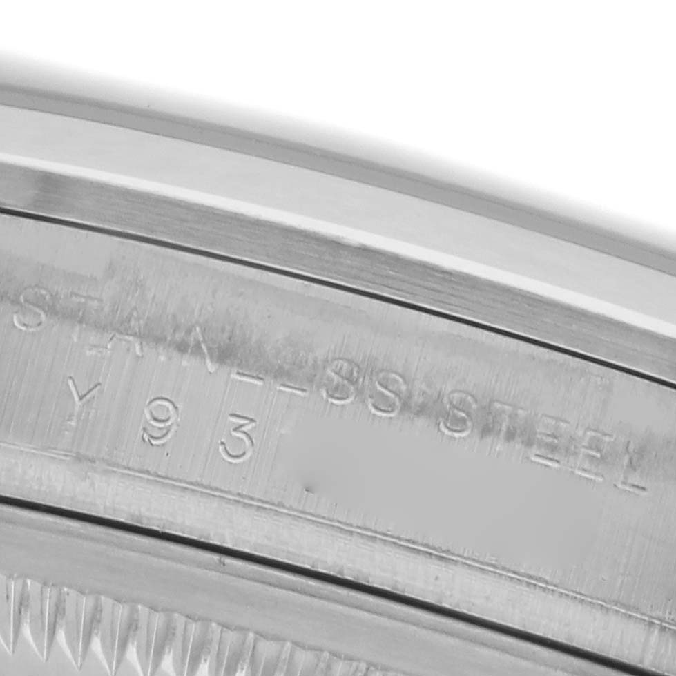 The image shows a close-up of the side engraving on the bezel of a Rolex Explorer 114270 Men's Stainless Steel Black Dial 114270 Men's Stainless Steel Black Dial watch, highlighting the stainless steel text.