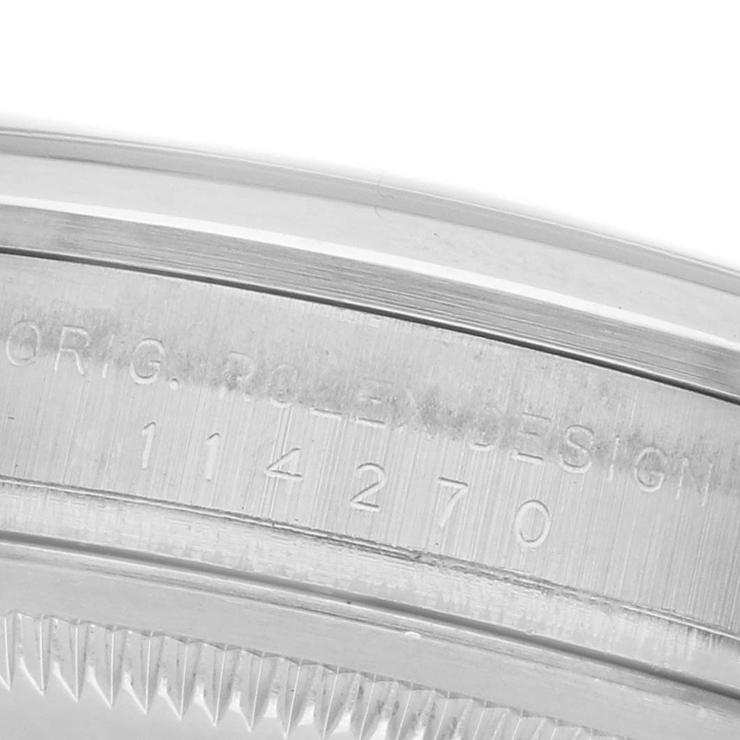 The image shows the engraved side view of the case edge of a Rolex Explorer 114270 Men's Stainless Steel Black Dial 114270 Men's Stainless Steel Black Dial watch.