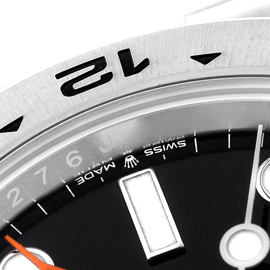 This close-up image shows the bezel, dial, and part of the hand of a Rolex Explorer 226570 Men's Stainless Steel Black Dial 226570 Men's Stainless Steel Black Dial watch.