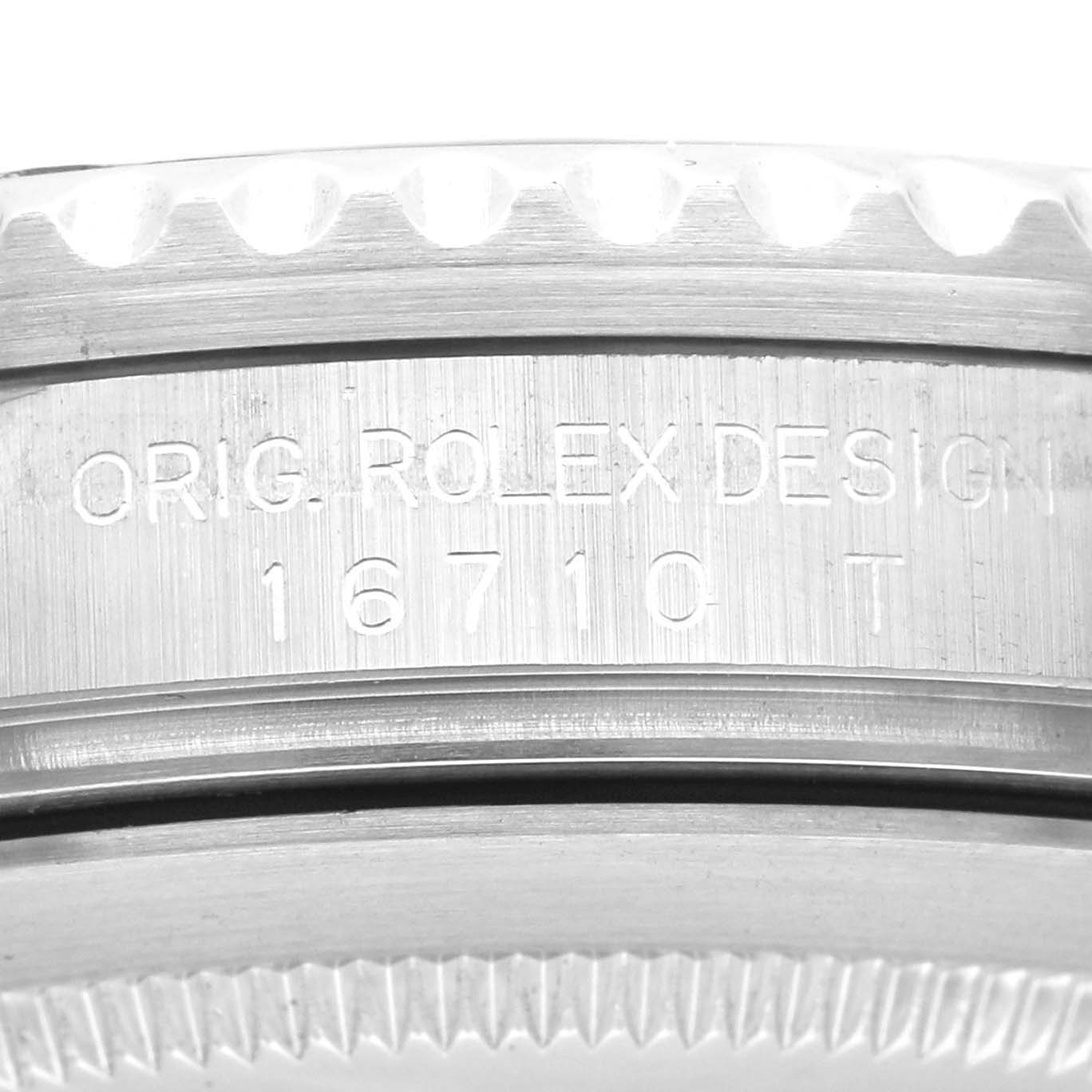 Close-up view of the case side of a Rolex GMT-Master 16710 Men's Stainless Steel Black Dial 16710 Men's Stainless Steel Black Dial, showing engraved text "ORIG. ROLEX DESIGN 16710 T".