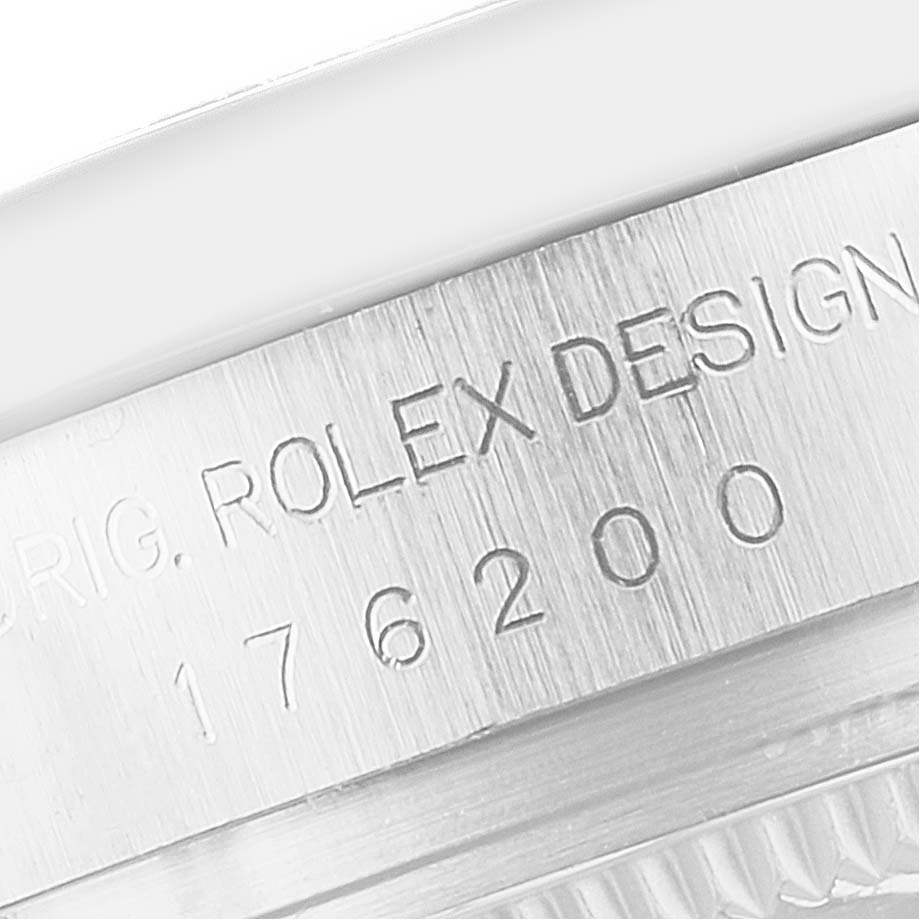 The image shows a close-up of the engraved side of the case on a Rolex Oyster Perpetual 176200 Women's Stainless Steel Silver Dial watch.