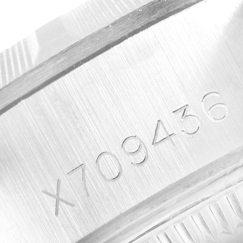 The image shows a close-up of the engraved serial number on the case of a Rolex Date 69190 Women
s Stainless Steel White Dial 69190 Women
s Stainless Steel White Dial watch.