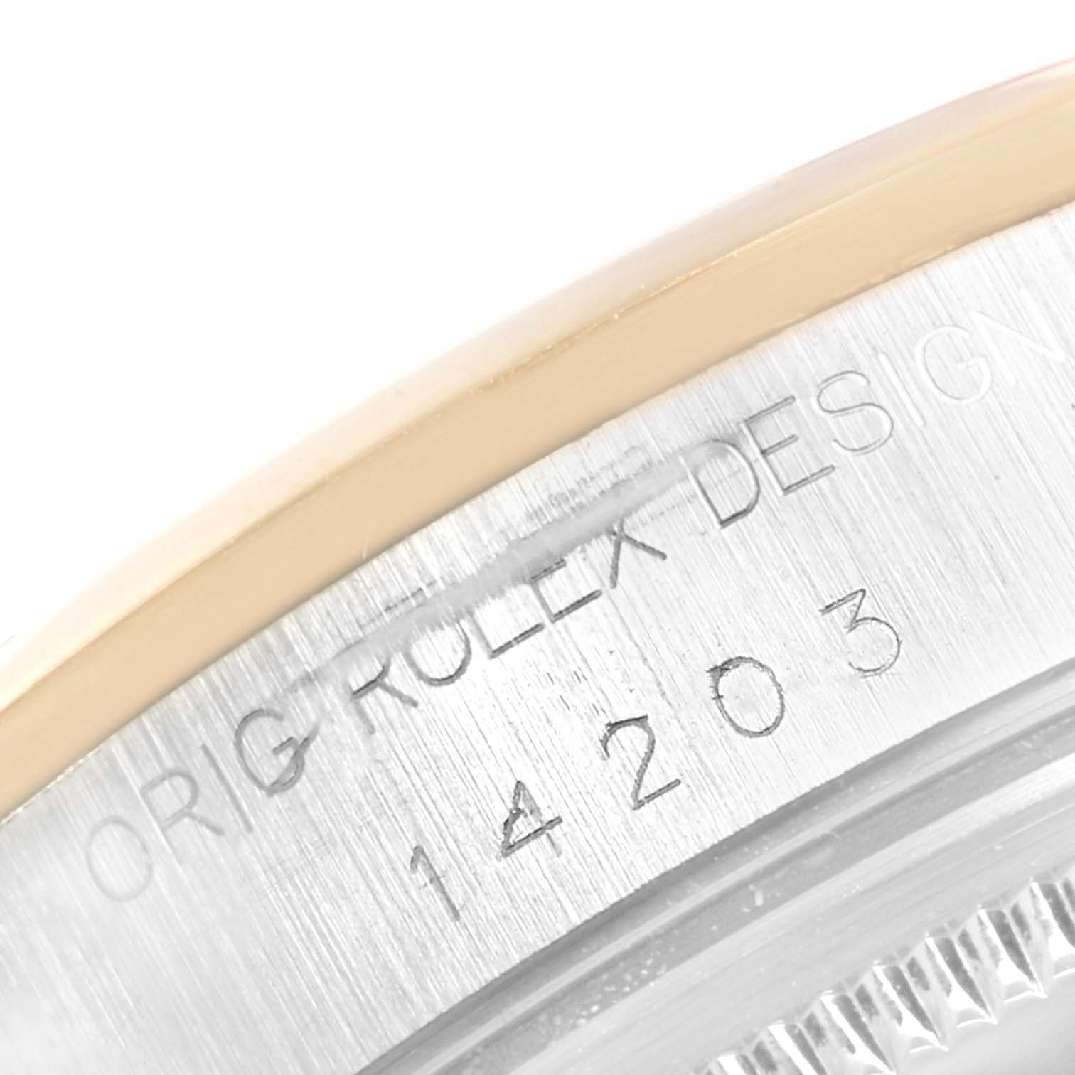 This image shows a close-up of the model number and Rolex branding inscribed on the side of the bezel of an Oyster Perpetual Rolex watch.