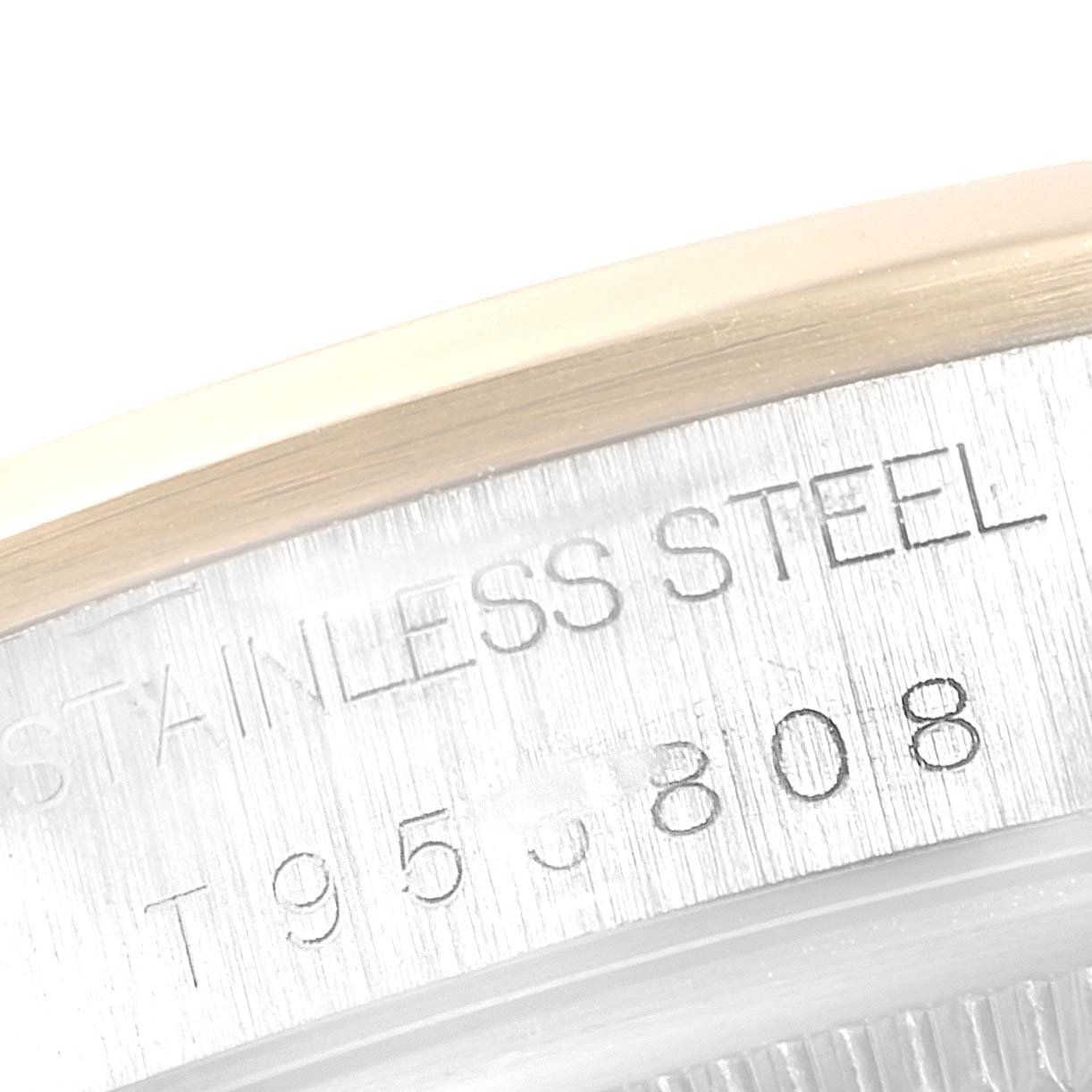 This image shows a close-up of the case back engraving on a Rolex Oyster Perpetual 14203 Men's Steel and Gold (two tone) White Dial 14203 Men's Steel and Gold (two tone) White Dial, highlighting the "STAINLESS STEEL" text.