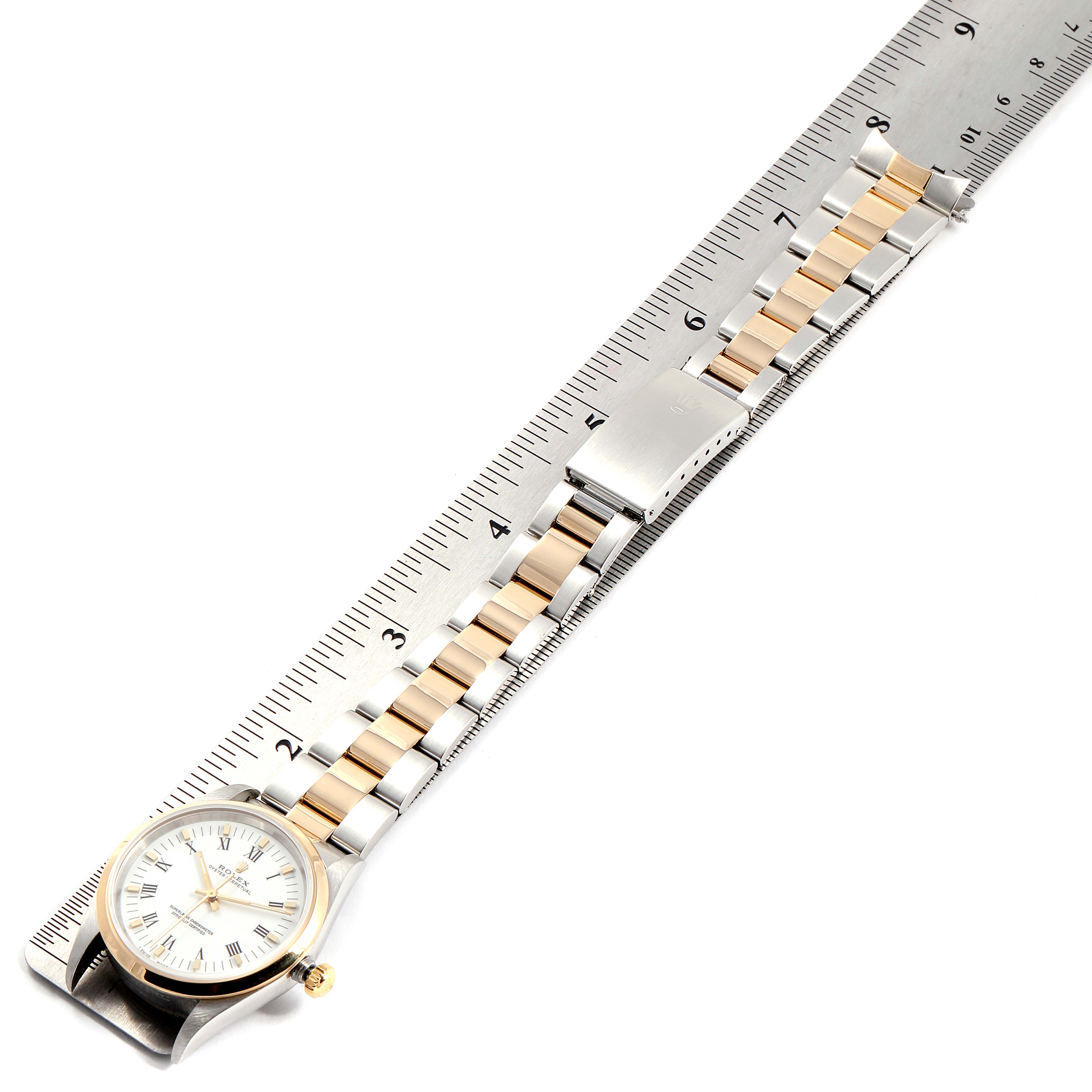 The image shows a top-down angle of a Rolex Oyster Perpetual 14203 Men's Steel and Gold (two tone) White Dial 14203 Men's Steel and Gold (two tone) White Dial watch, with the bracelet aligned next to a ruler for measurement.