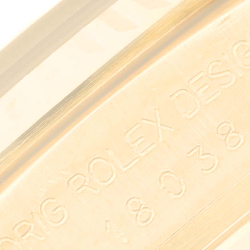 This image shows a close-up of the side of the Rolex President 18038 Men's Yellow Gold Black Dial 18038 Men's Yellow Gold Black Dial model watch, featuring engravings on the inner bezel.