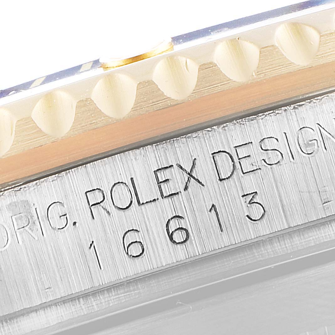 The image shows a close-up of the bezel and inscribed model number "16613" on a Rolex Submariner 16613 Men
s Steel and Gold (two tone) Blue Dial 16613 Men
s Steel and Gold (two tone) Blue Dial watch.