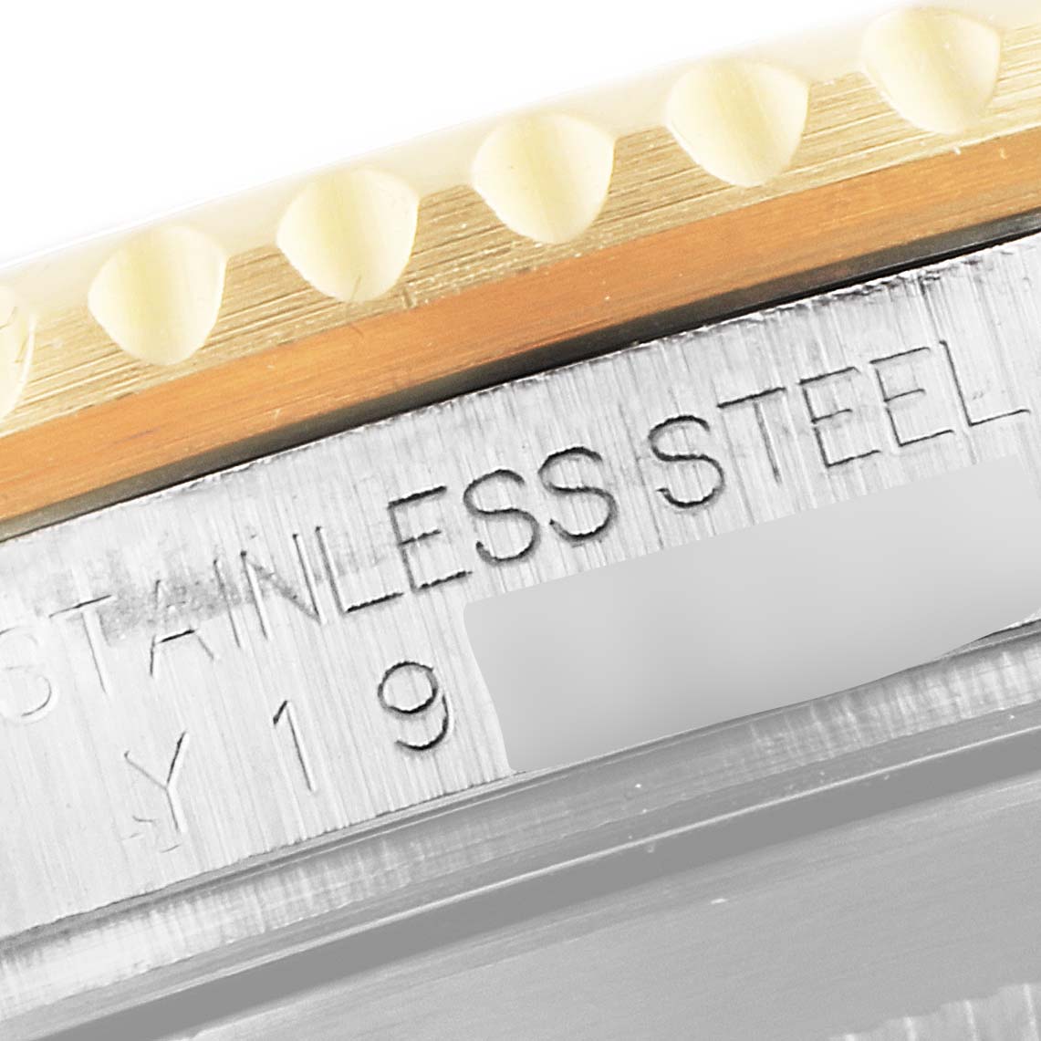 The image shows a close-up of the side of the bezel and case with the "STAINLESS STEEL" engraving on a Rolex Submariner 16613 Men
s Steel and Gold (two tone) Blue Dial 16613 Men
s Steel and Gold (two tone) Blue Dial watch.