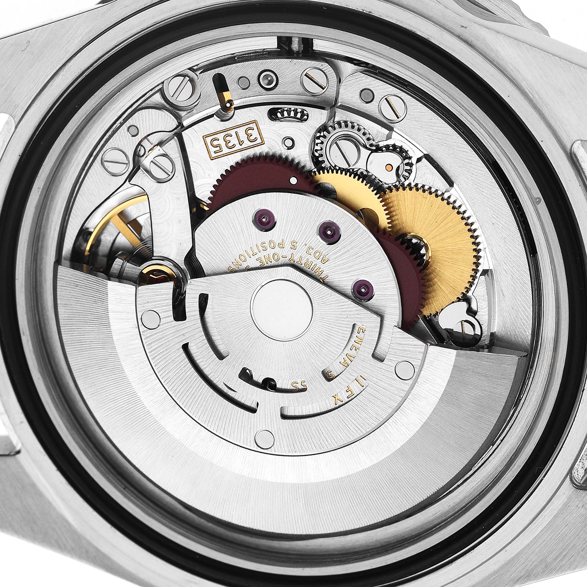 The image shows the movement mechanism of the Rolex Submariner 16610 T Men's Stainless Steel Black Dial, viewed from the back, highlighting gears and components.