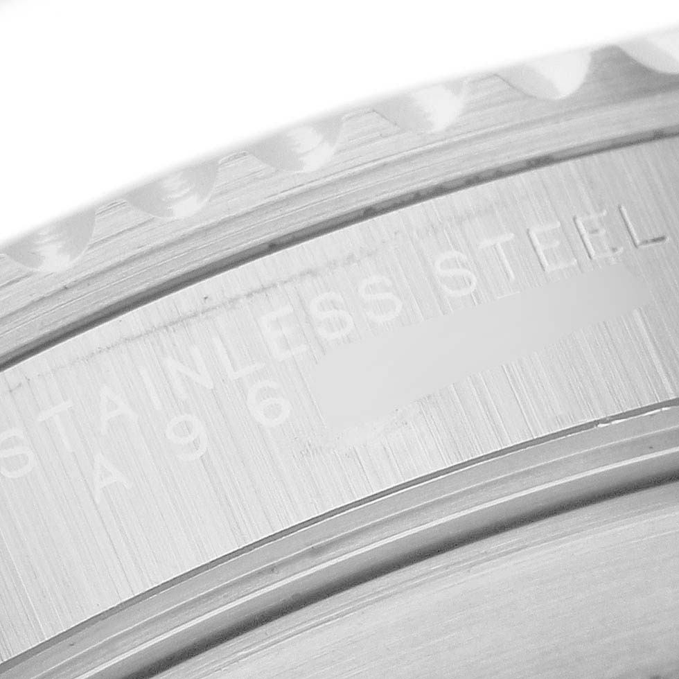 The image shows a close-up of the engraved case side of a Rolex Submariner 14060 Men's Stainless Steel Black Dial, highlighting the "STAINLESS STEEL" marking.
